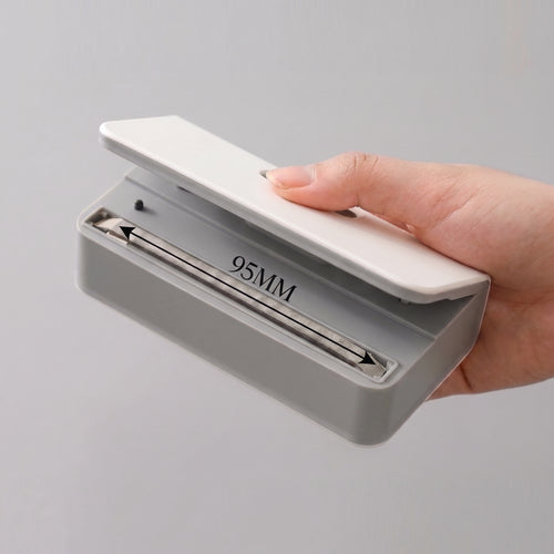 Hand opening the lid of the white Portable Sealer to show the heating strip